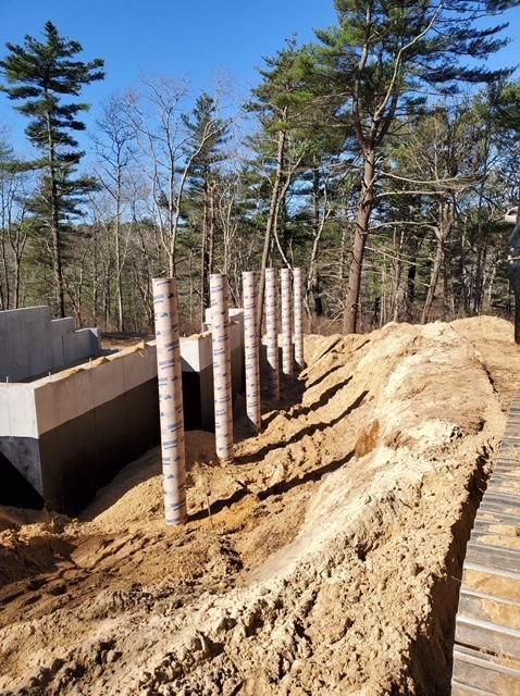 A pile of dirt with trees in the background