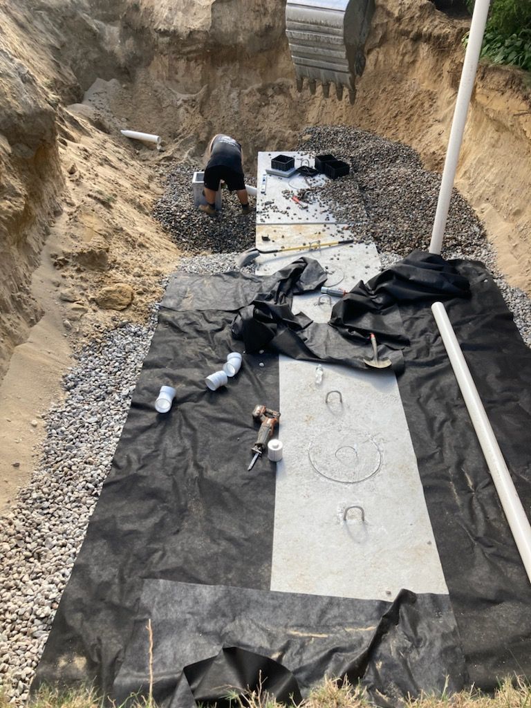 A man is digging a hole in the ground.