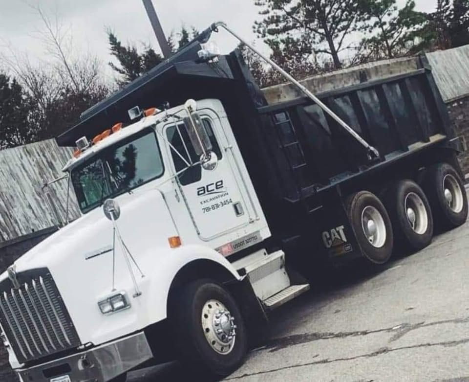 A dump truck with the word ace on the side