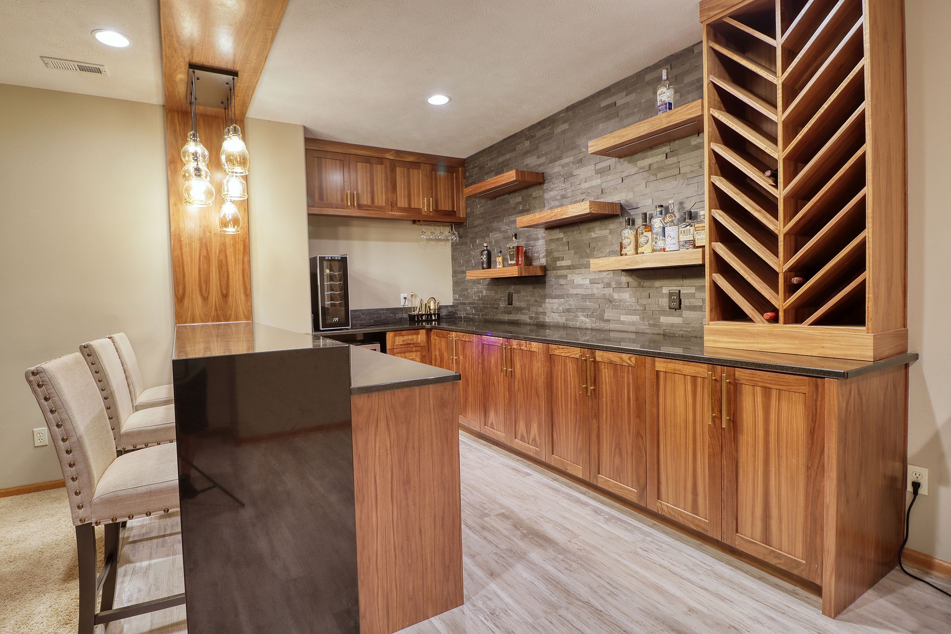 A kitchen with wooden cabinets and a wine rack.