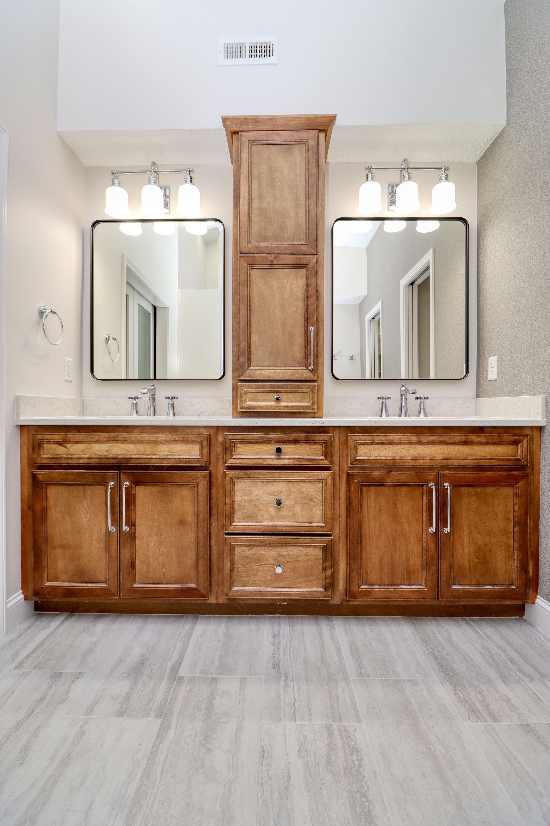 A bathroom with two sinks and two mirrors.