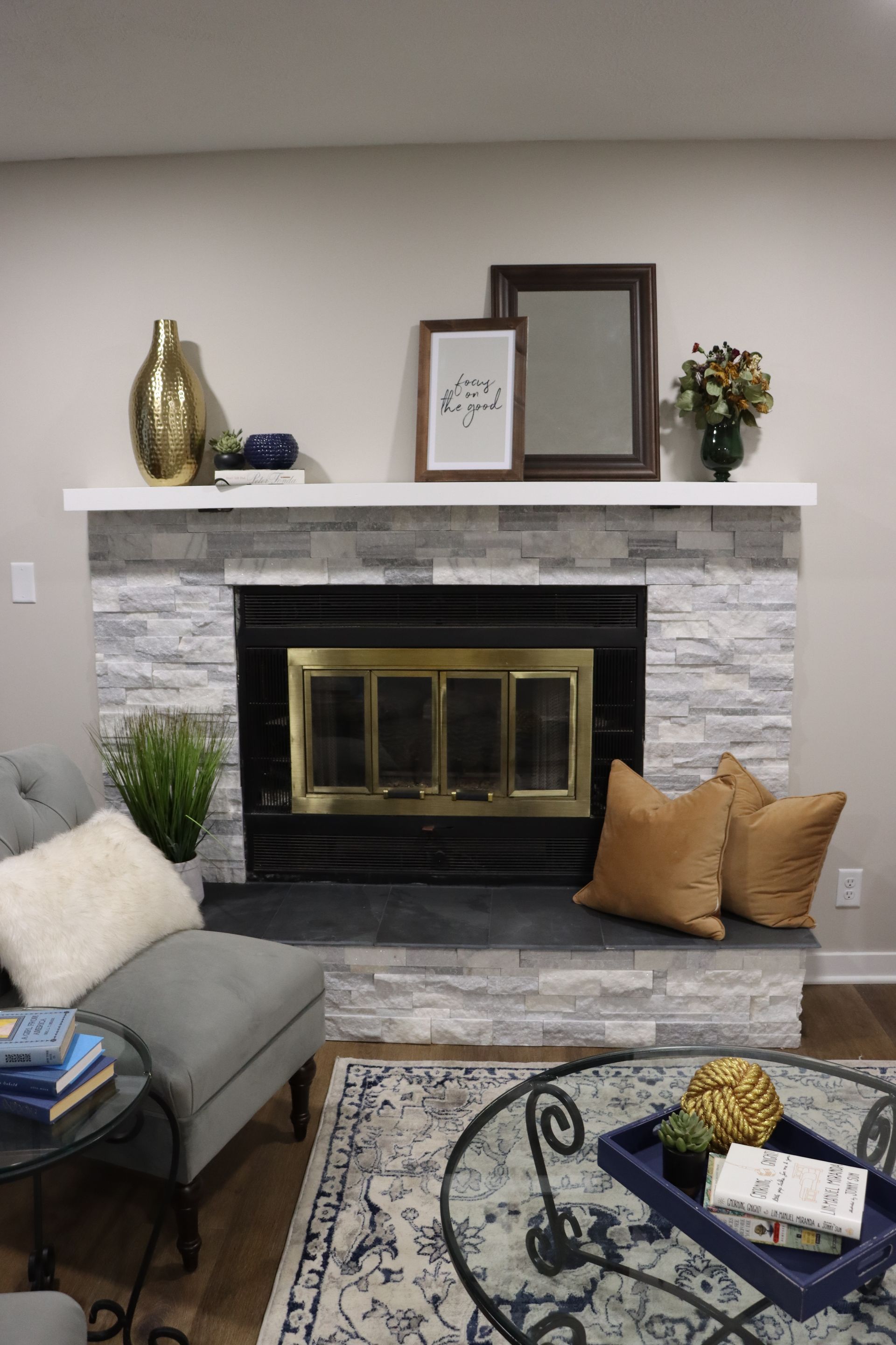 There is a fireplace in the middle of the living room.