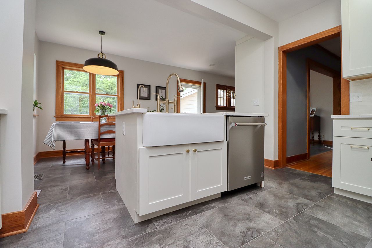 A kitchen with a large island and a sink.