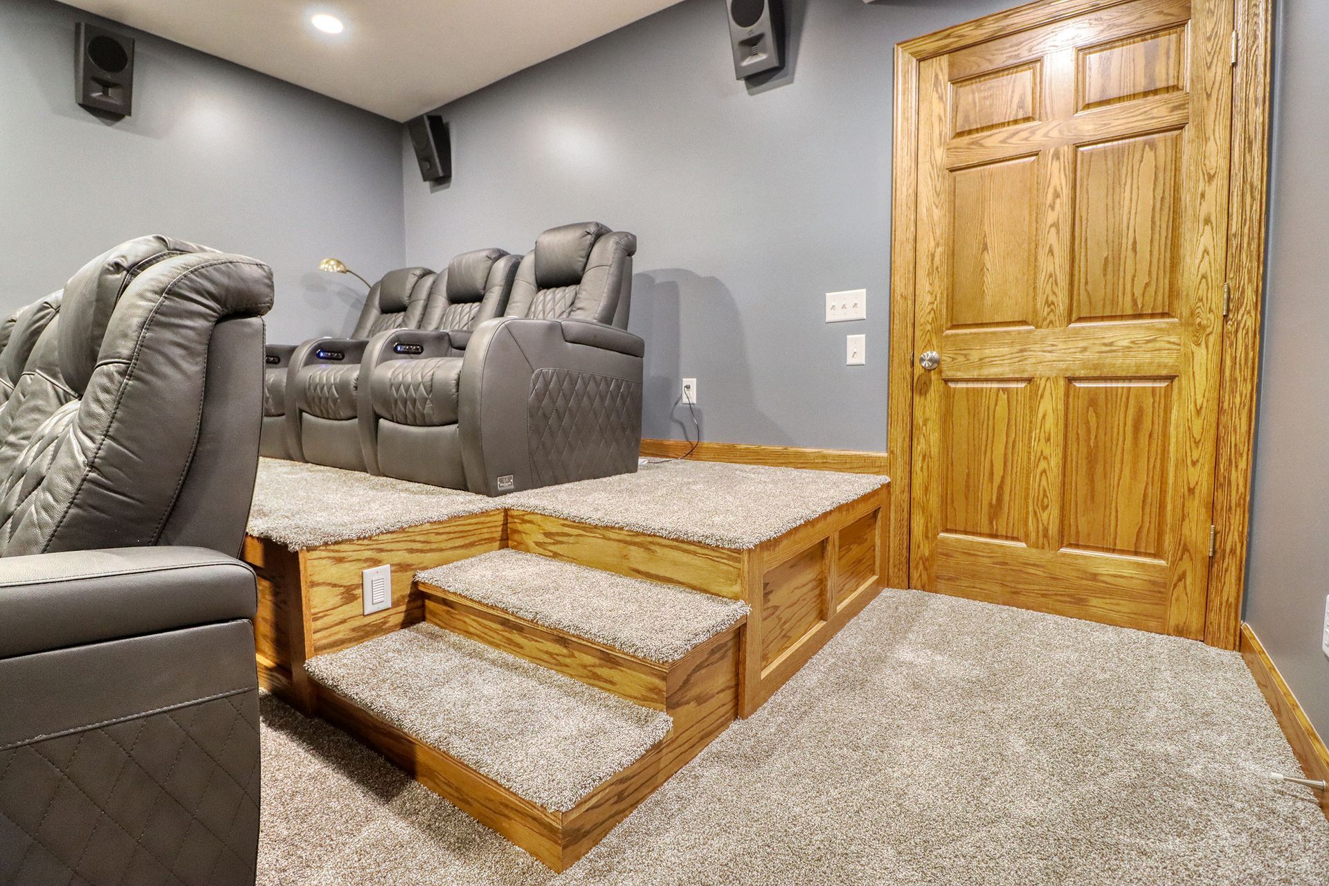 A home theater with a lot of chairs and stairs.