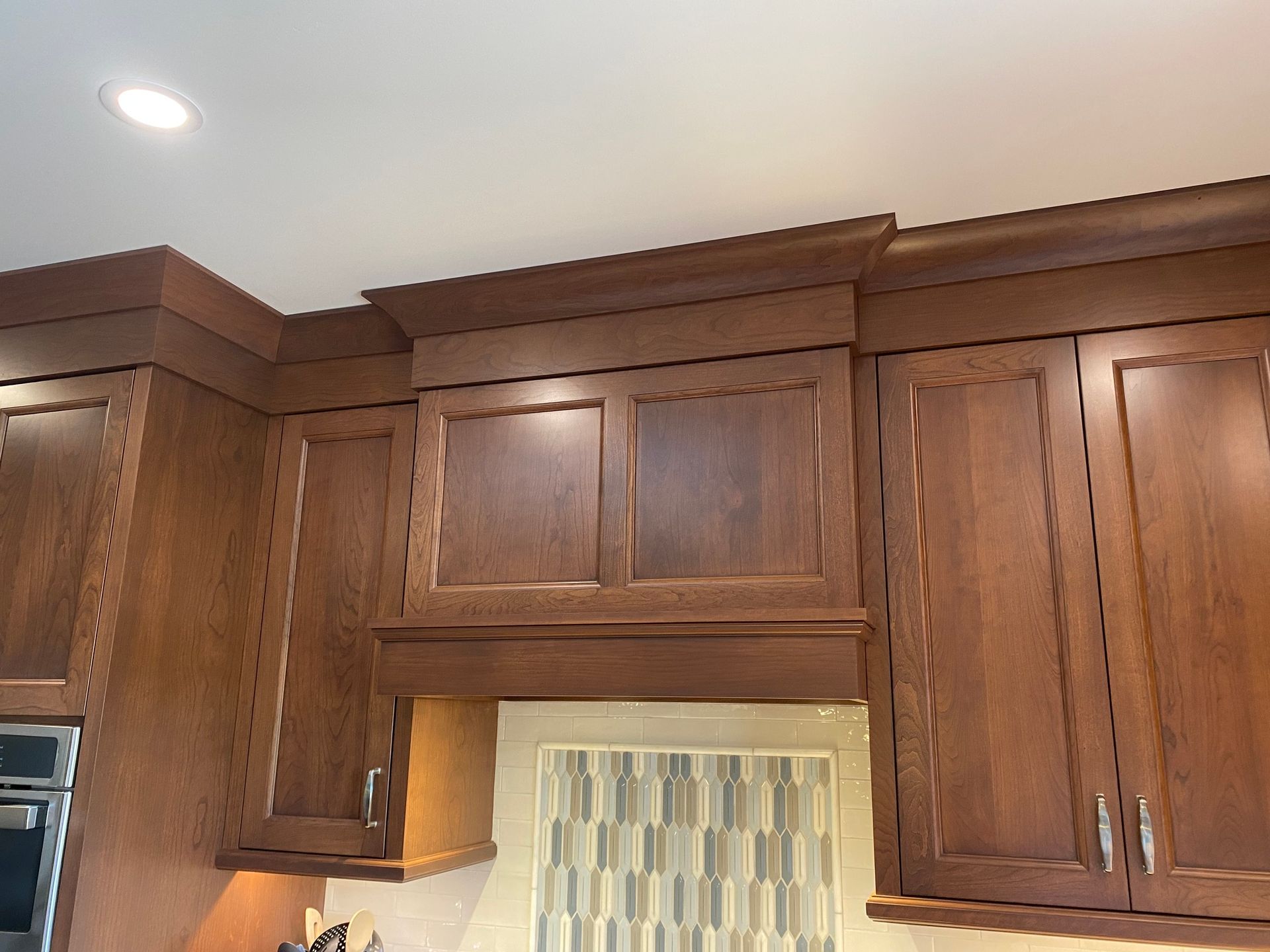 a kitchen with wooden cabinets and stainless steel appliances