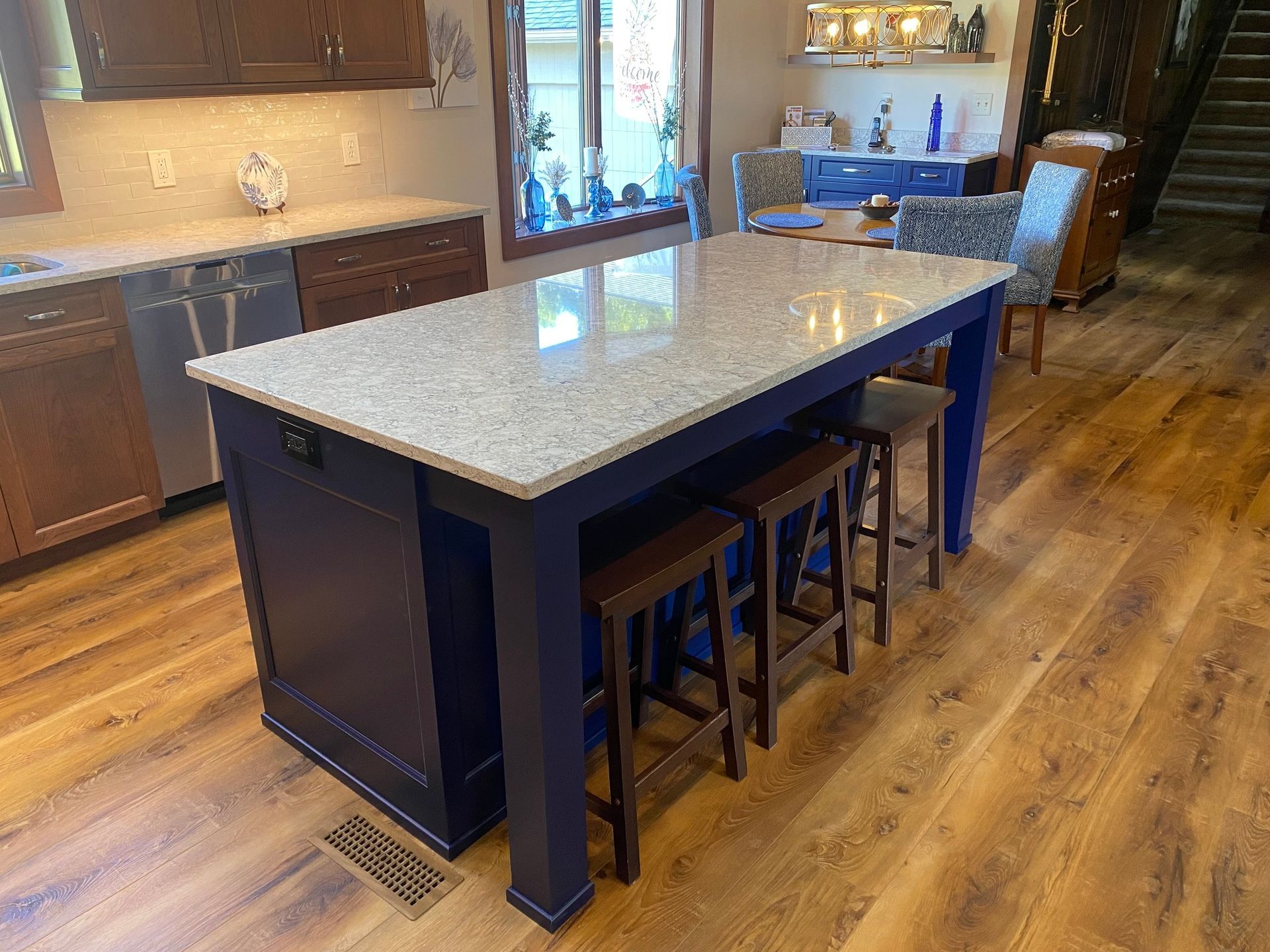 a kitchen with a large island and stools