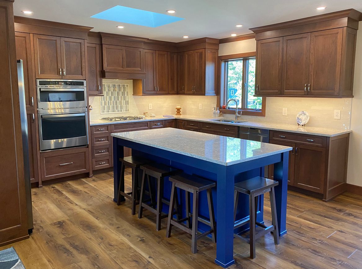 a kitchen with a large blue island and stools