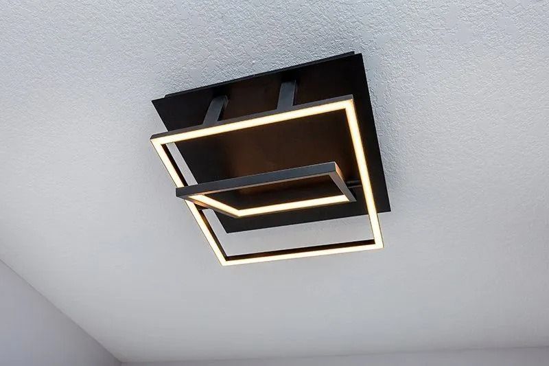 Modern black ceiling light fixture with two illuminated square frames.