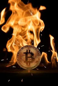 Bitcoin coin burning amid flames on a dark background