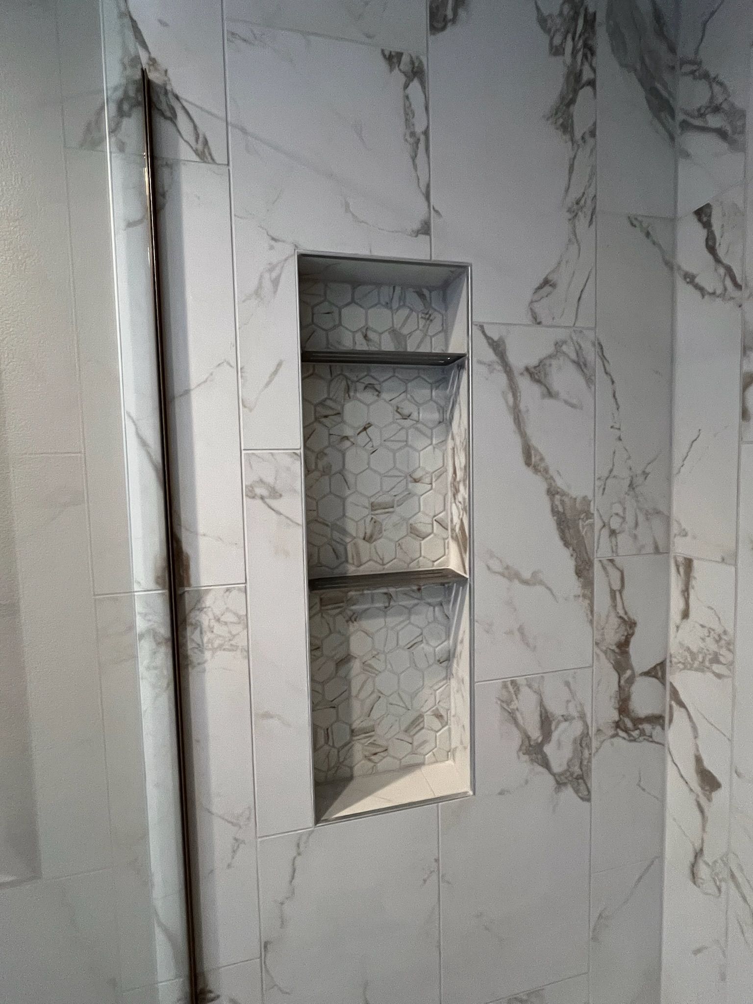 Marble-pattern wall with a recessed rectangular niche or shelf opening