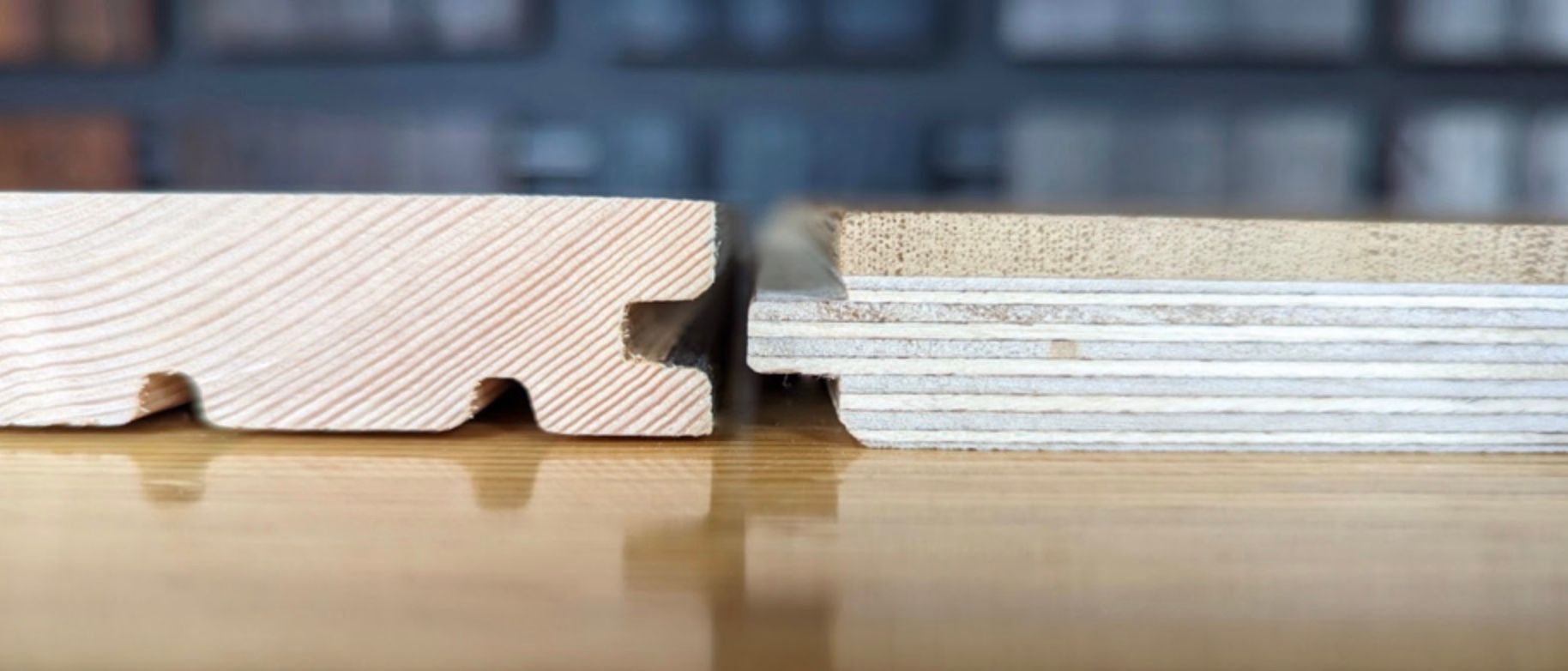 Cross-section of two wood floorboards, one solid wood, the other layered, showing their interlocking edges.