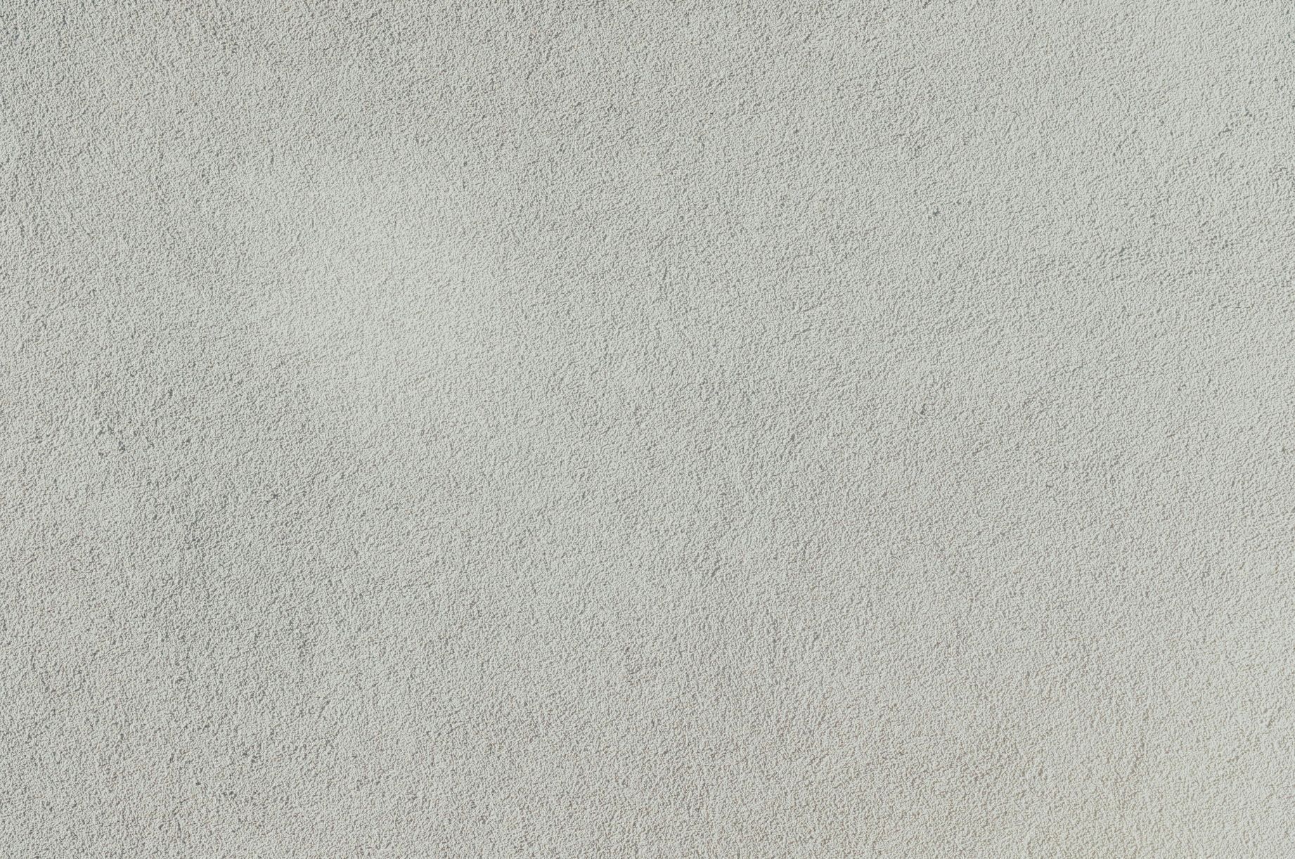 Light gray, textured wall.