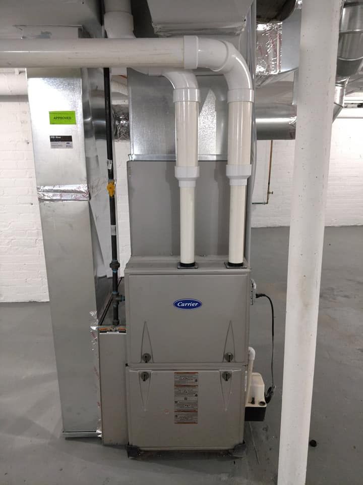 A heating and cooling system is installed in a basement.