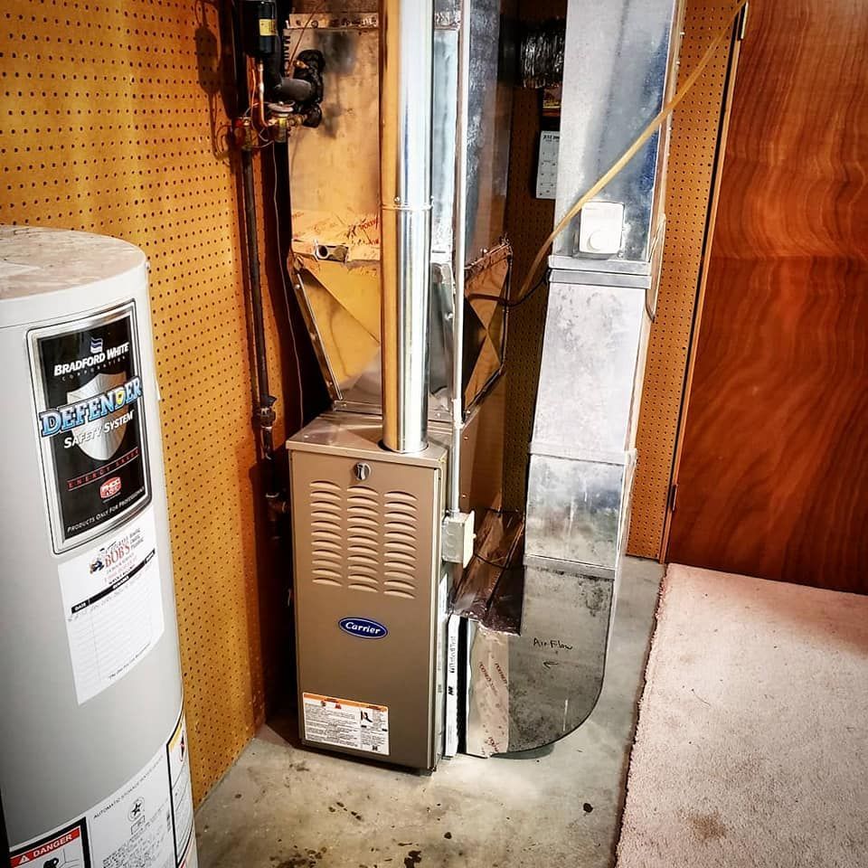 A water heater in a basement with a sticker on it that says diamond