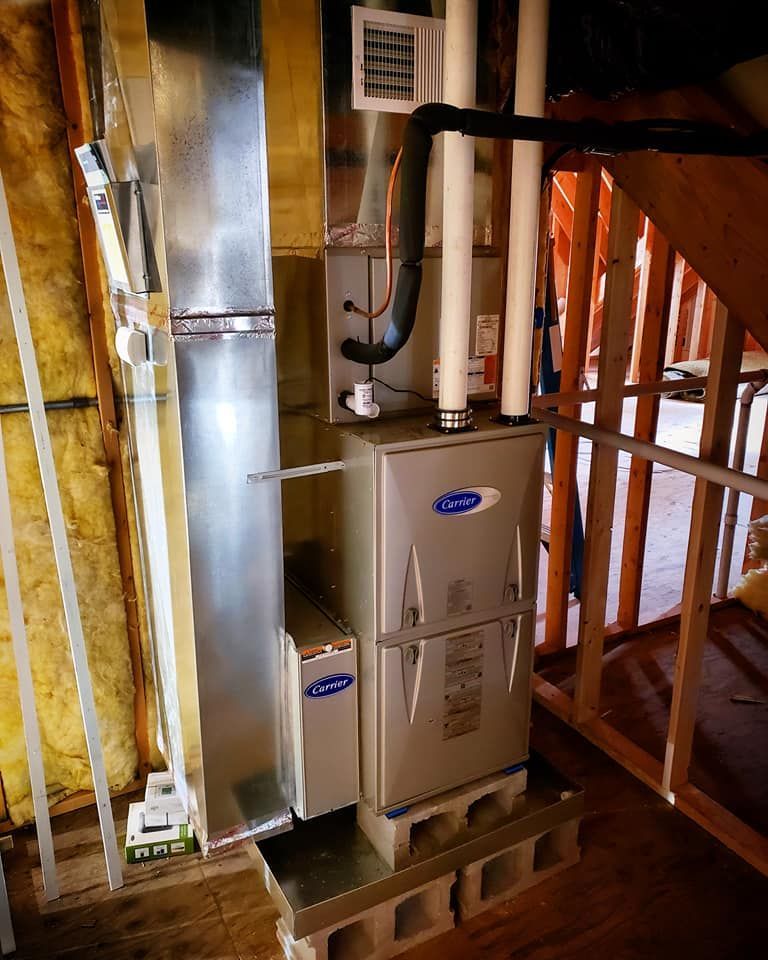 A carrier air conditioner is installed in the attic of a house.