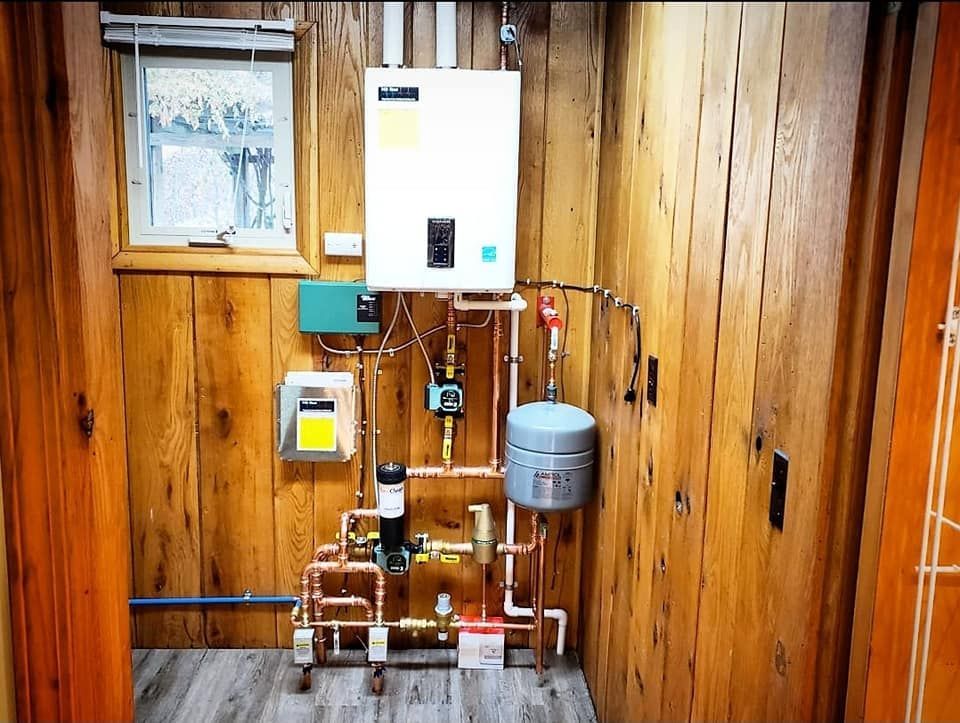A room with wood paneling and a boiler on the wall.