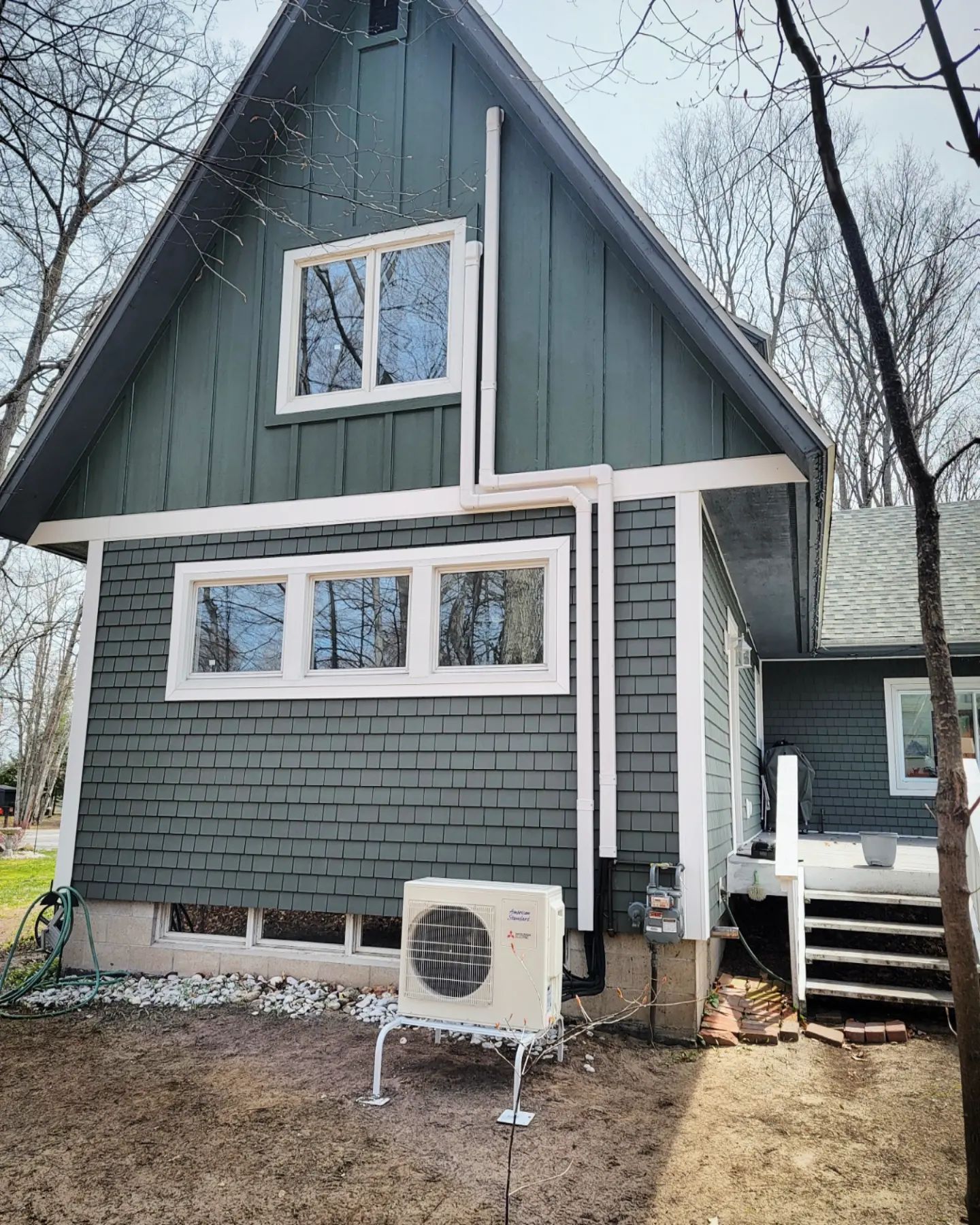 A small house with a large air conditioner on the side of it.
