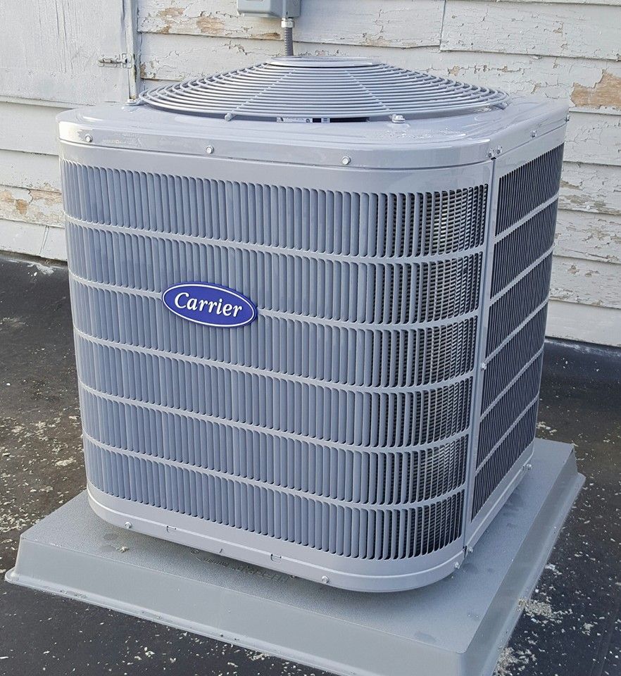 A carrier air conditioner sits outside of a building