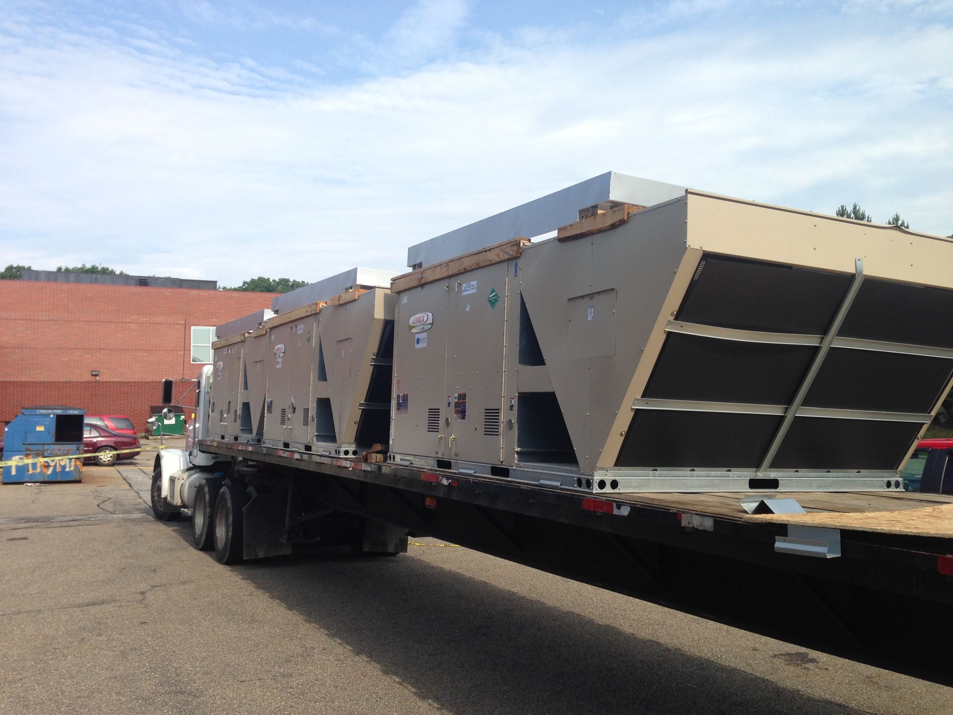 A semi truck is carrying a large stack of boxes.
