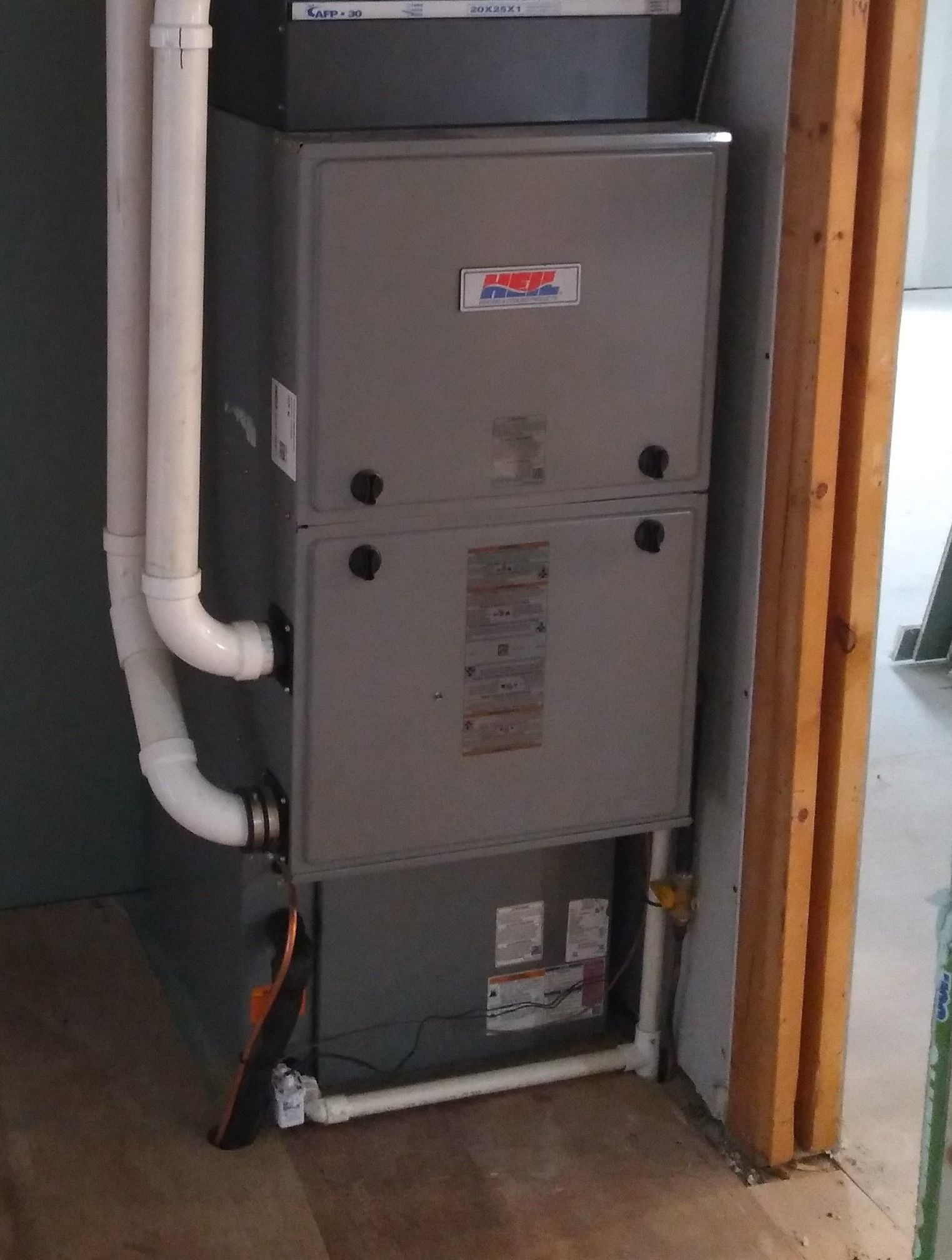 An air conditioner is sitting in a room next to a door