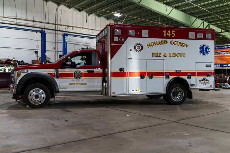 A howard county fire and rescue ambulance is parked in a garage.