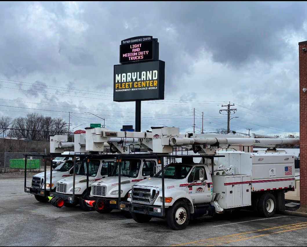 A fleet of trucks parked in front of a maryland fleet service sign