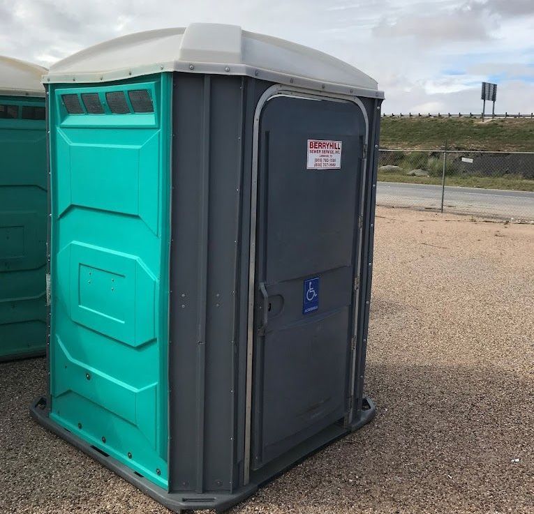 A portable toilet with a handicap sign on the door