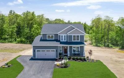 A kitchen with stainless steel appliances, granite counter tops, and a large island.