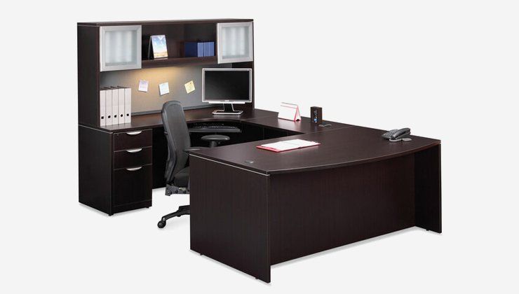 a desk with a computer on it and a chair