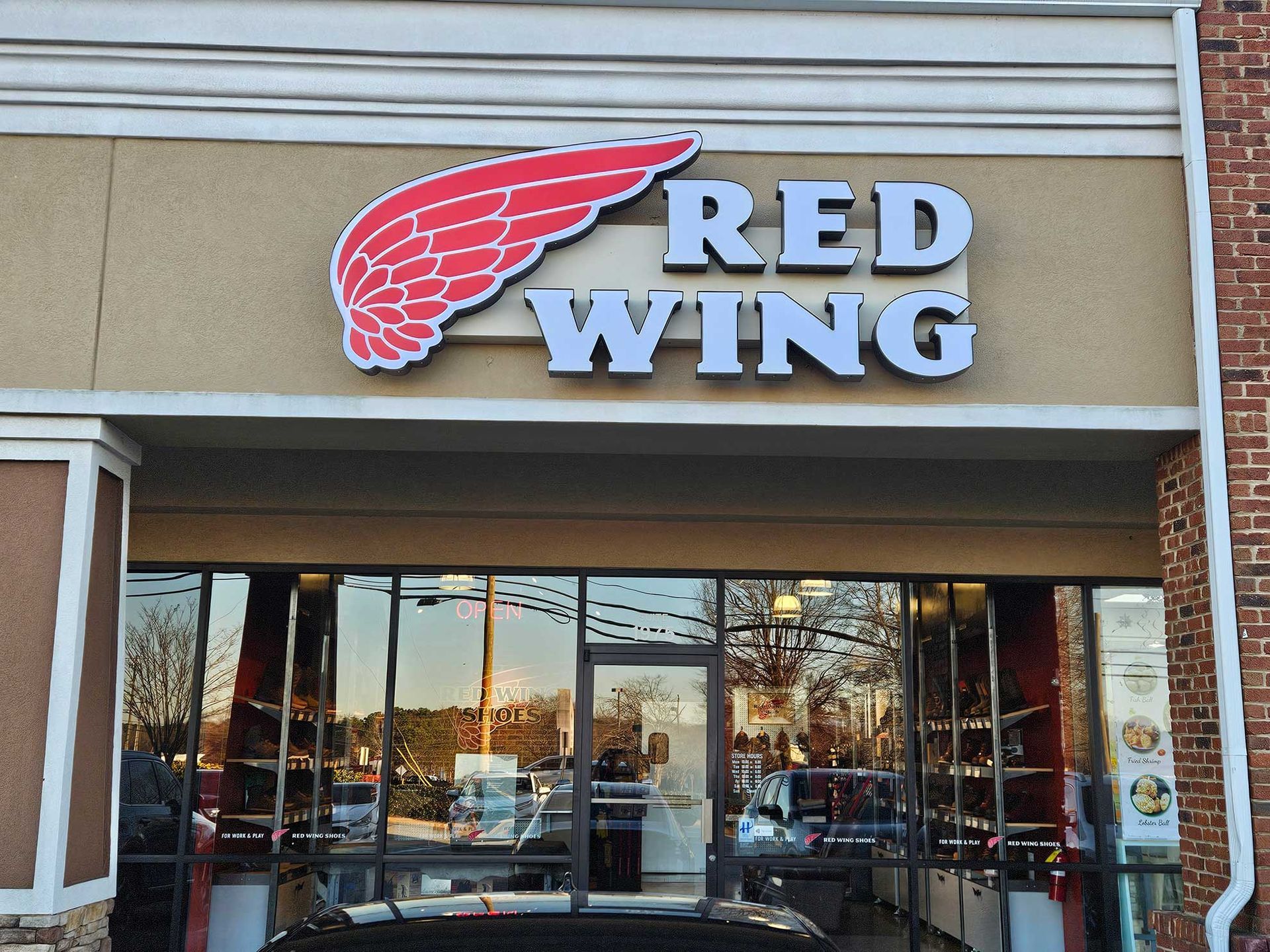 Red Wing store exterior with logo and large windows.