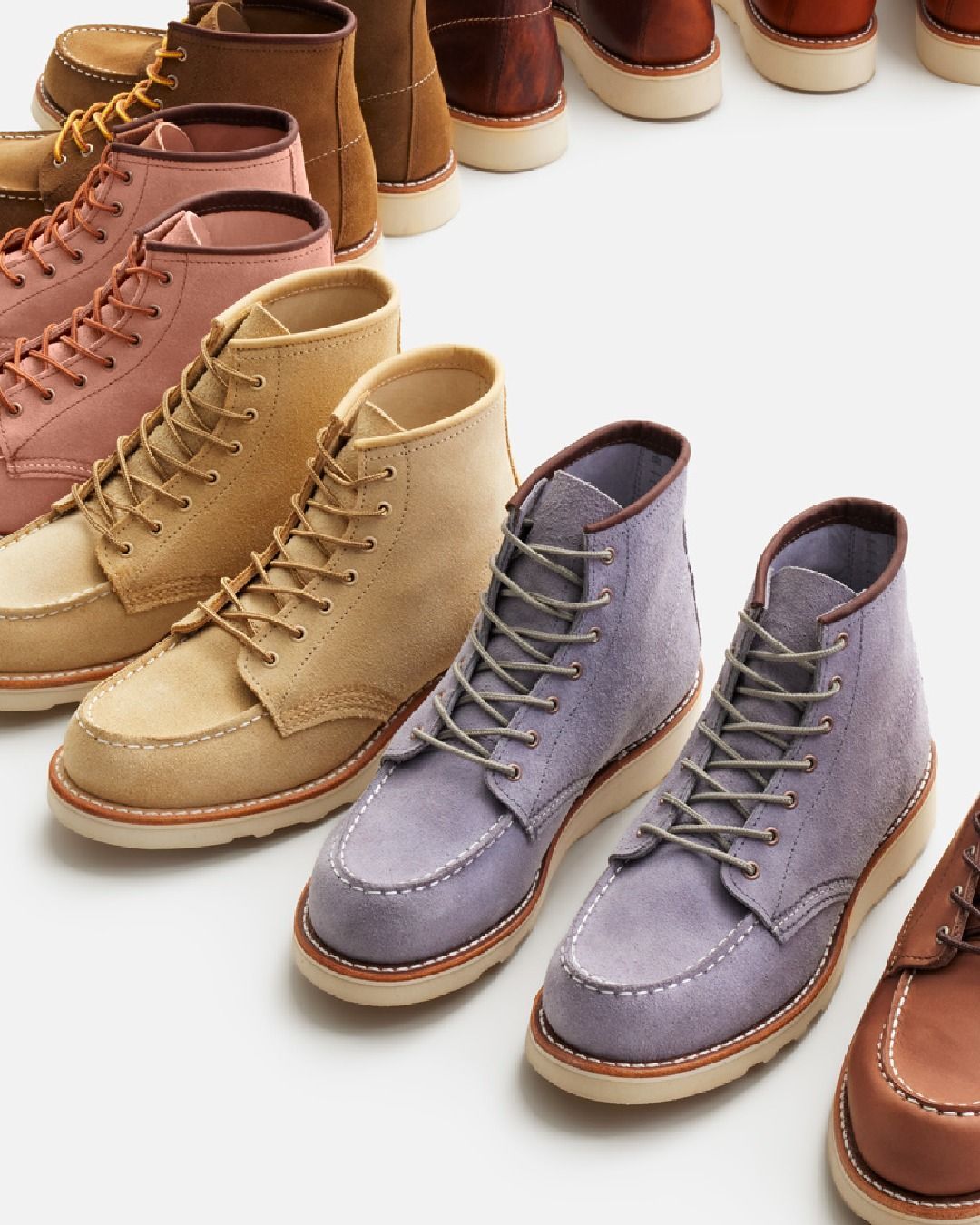 Row of colorful suede moccasin boots.