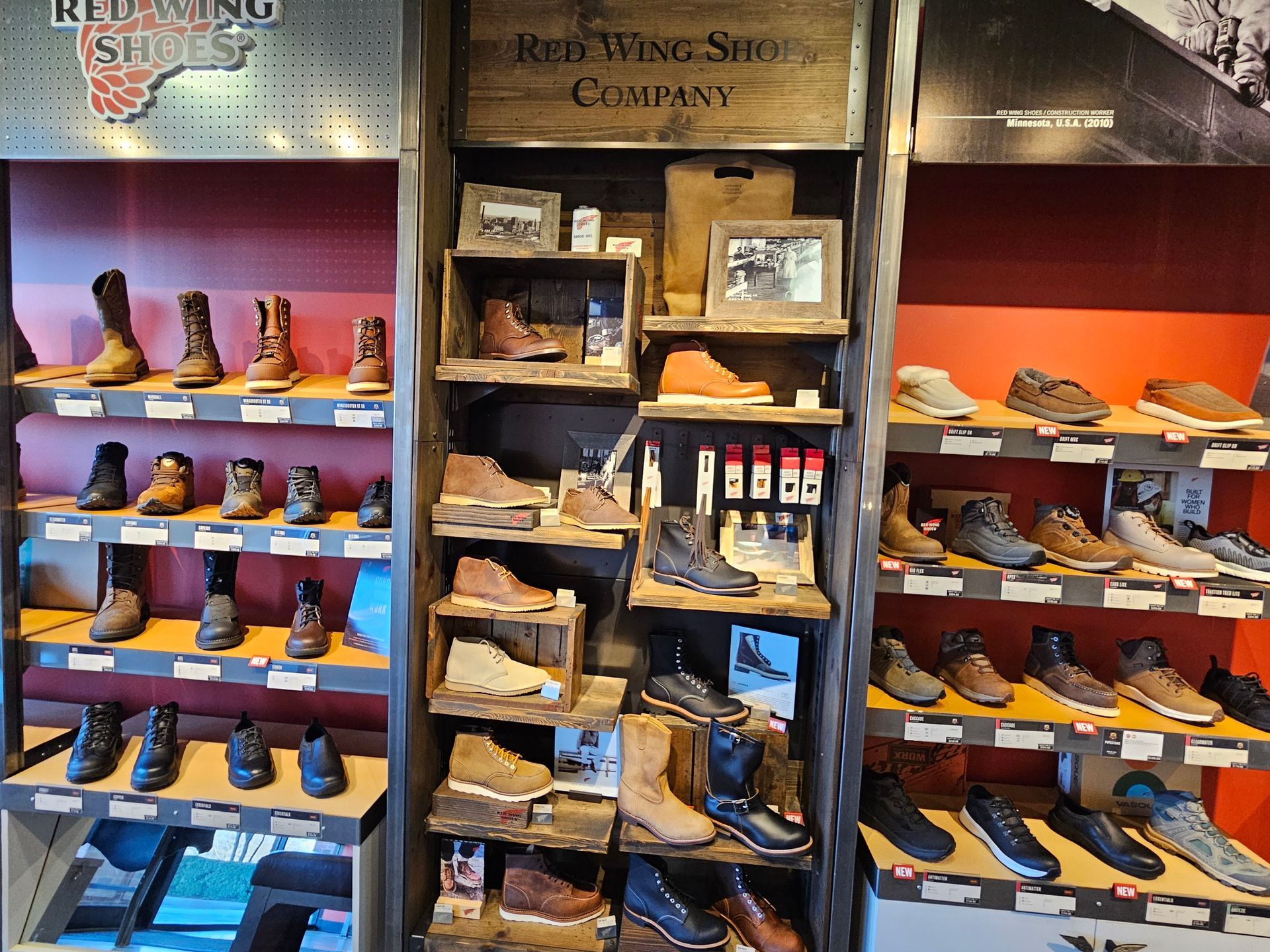 Red Wing Shoes display in a store, showcasing various boots and work shoes on shelves.