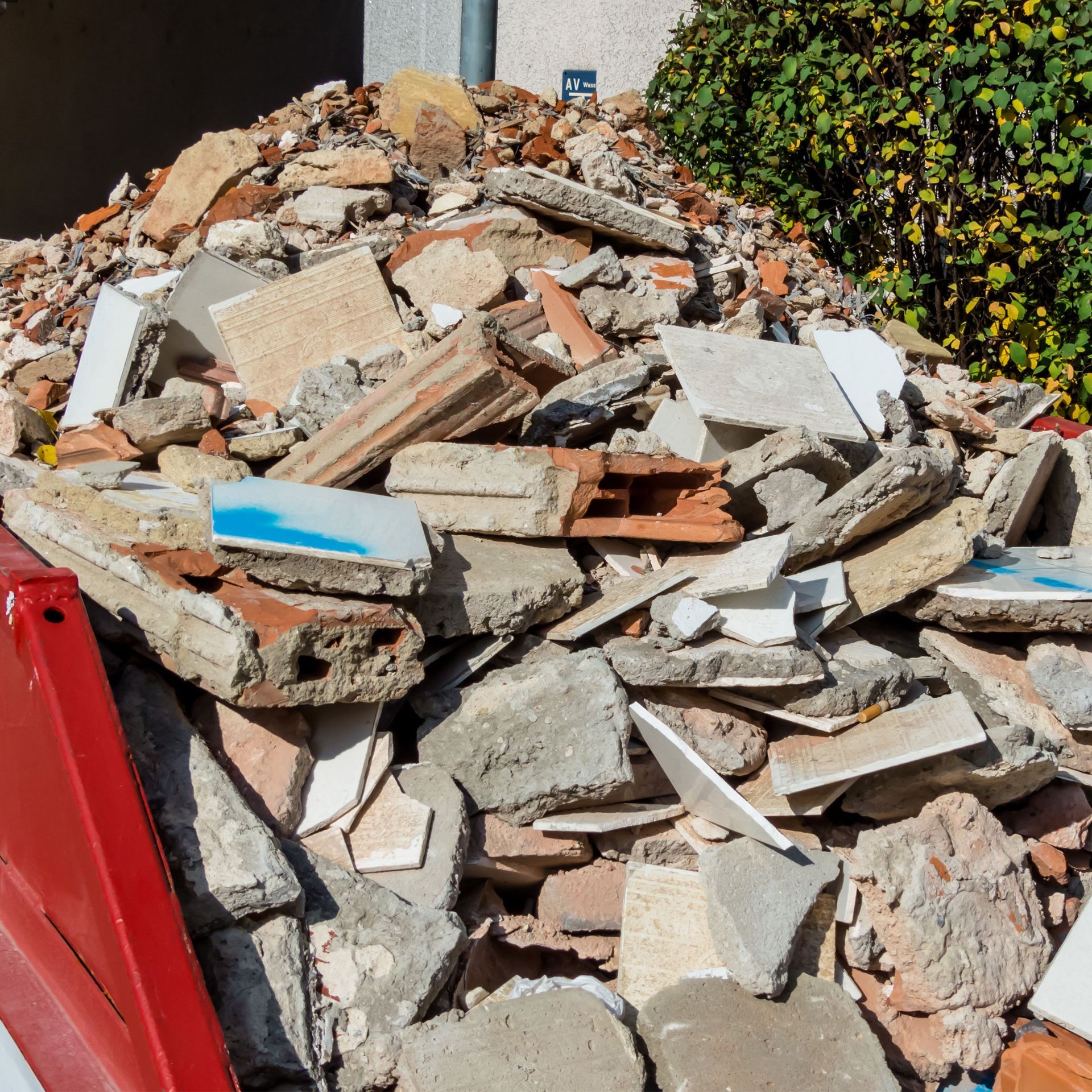 Pile of construction debris in a red dumpster