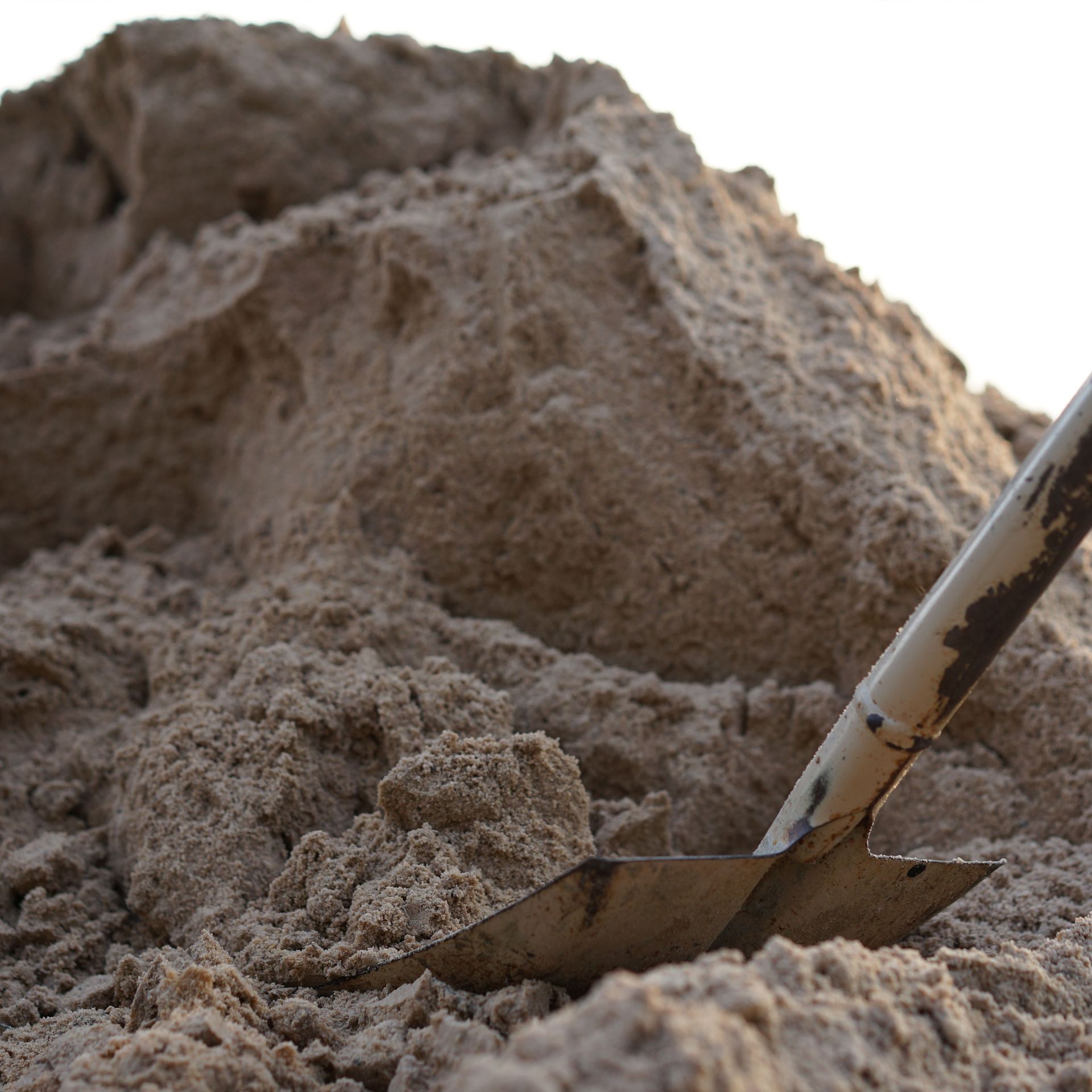 Pile of dirt with a shovel resting in it
