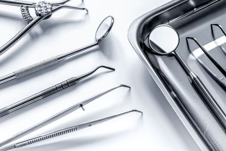 A tray of dental instruments is sitting on a table.