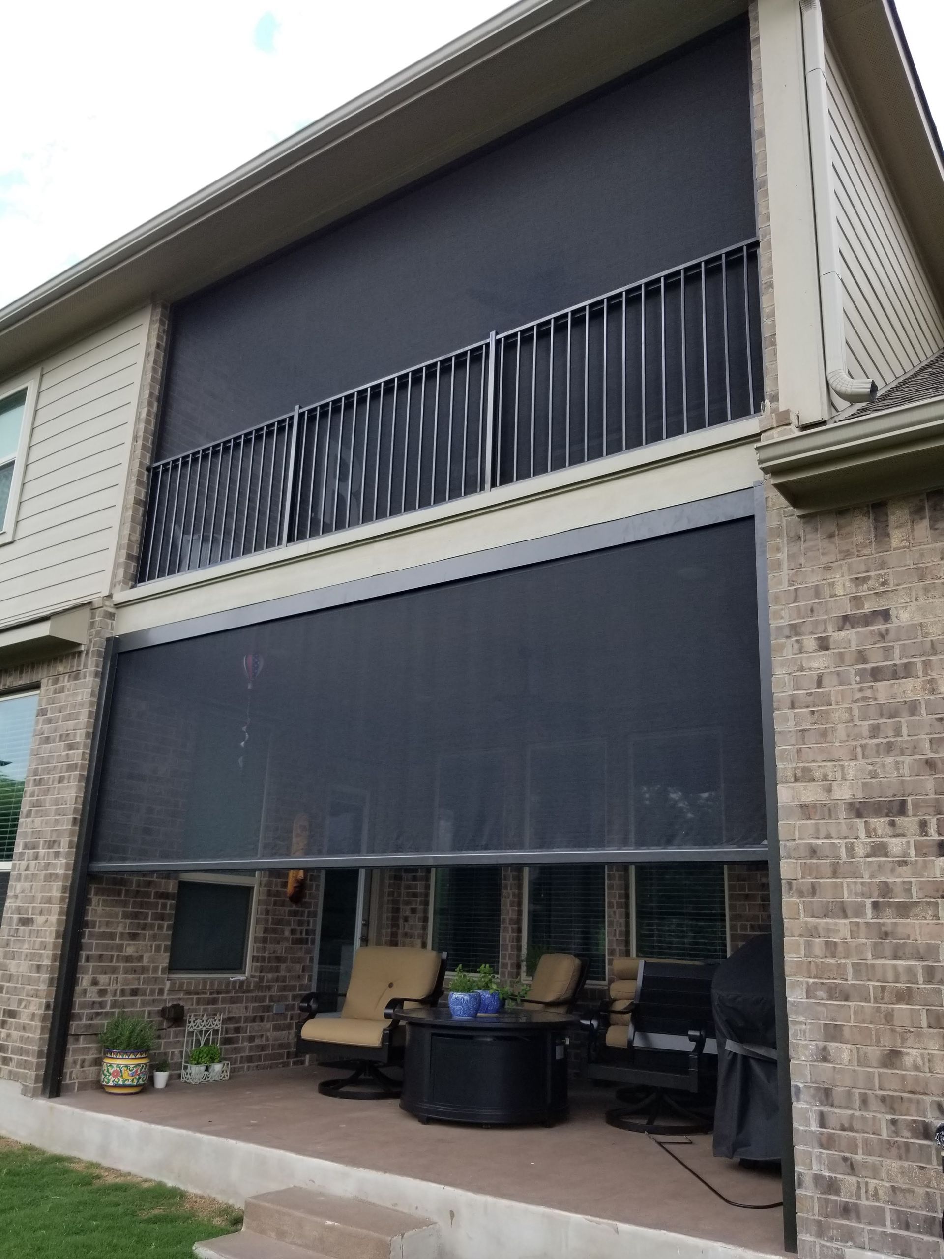 a house with a balcony and a screened in porch .