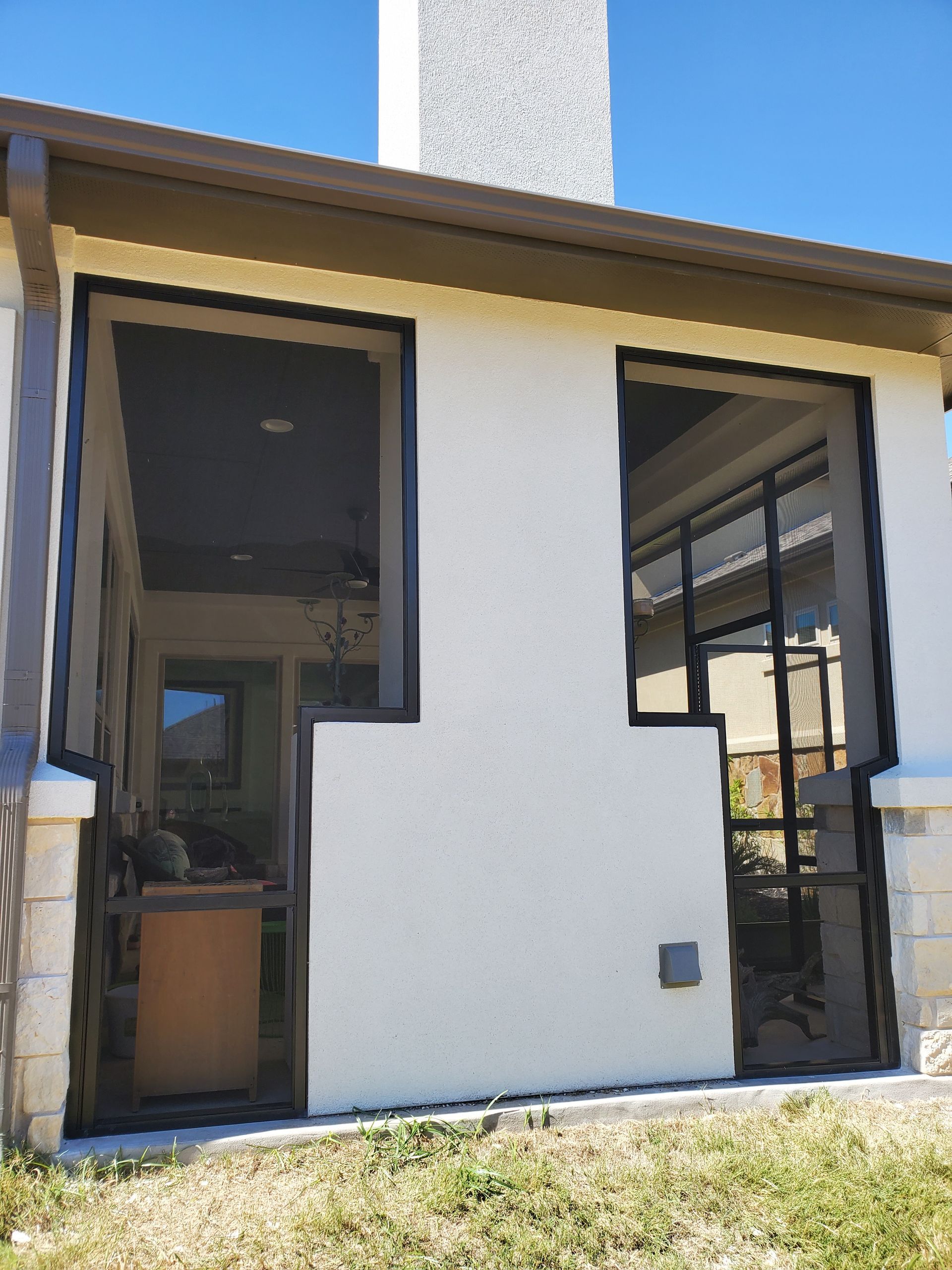 a white house with a lot of windows and a chimney .