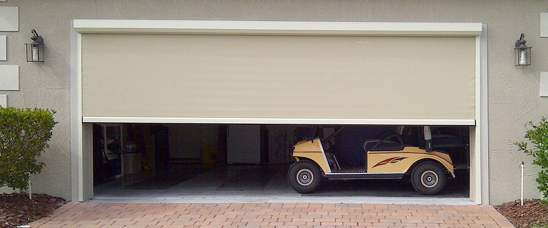 a golf cart is parked in a garage door .