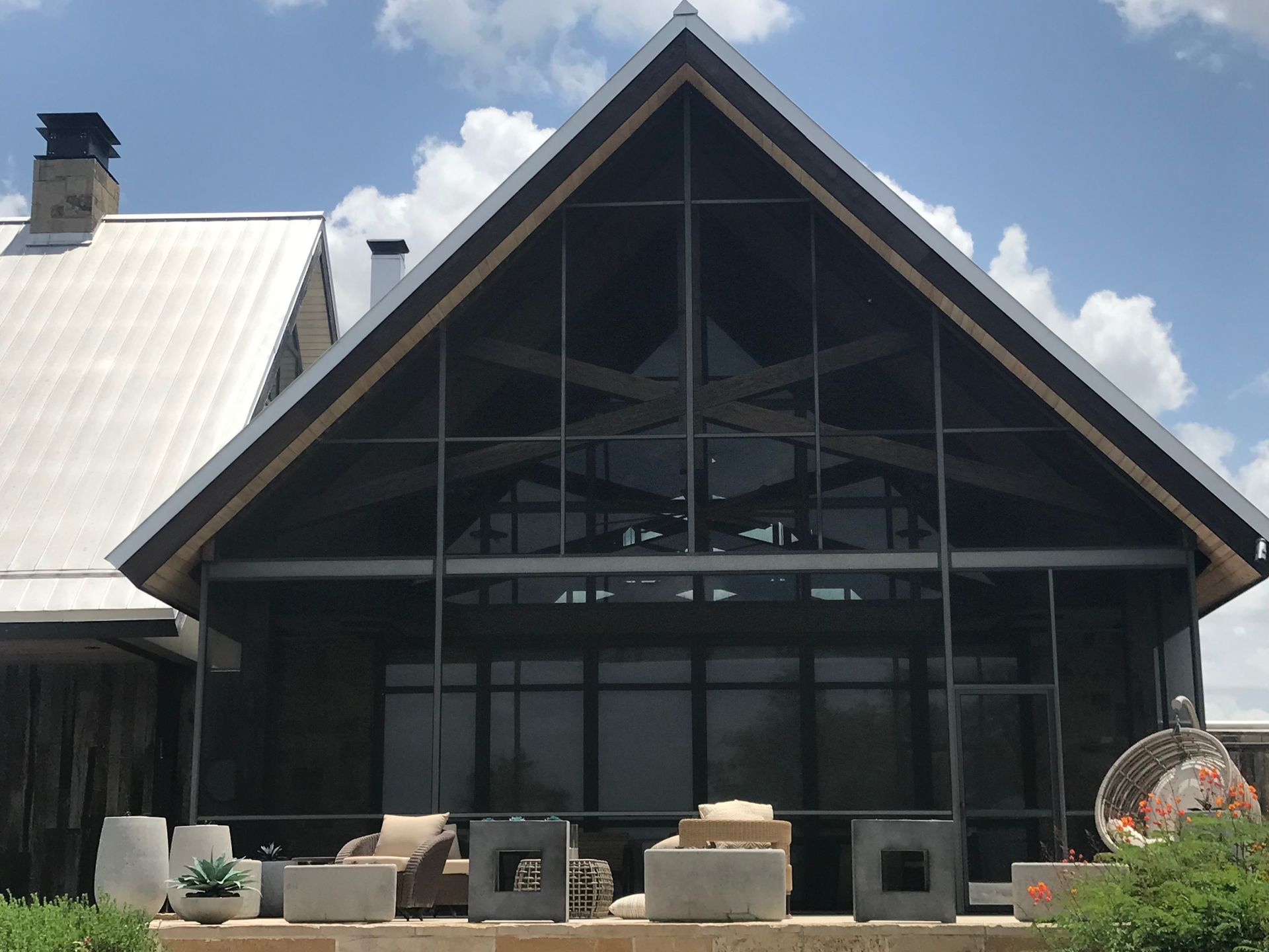 a large house with a triangle shaped roof and lots of windows