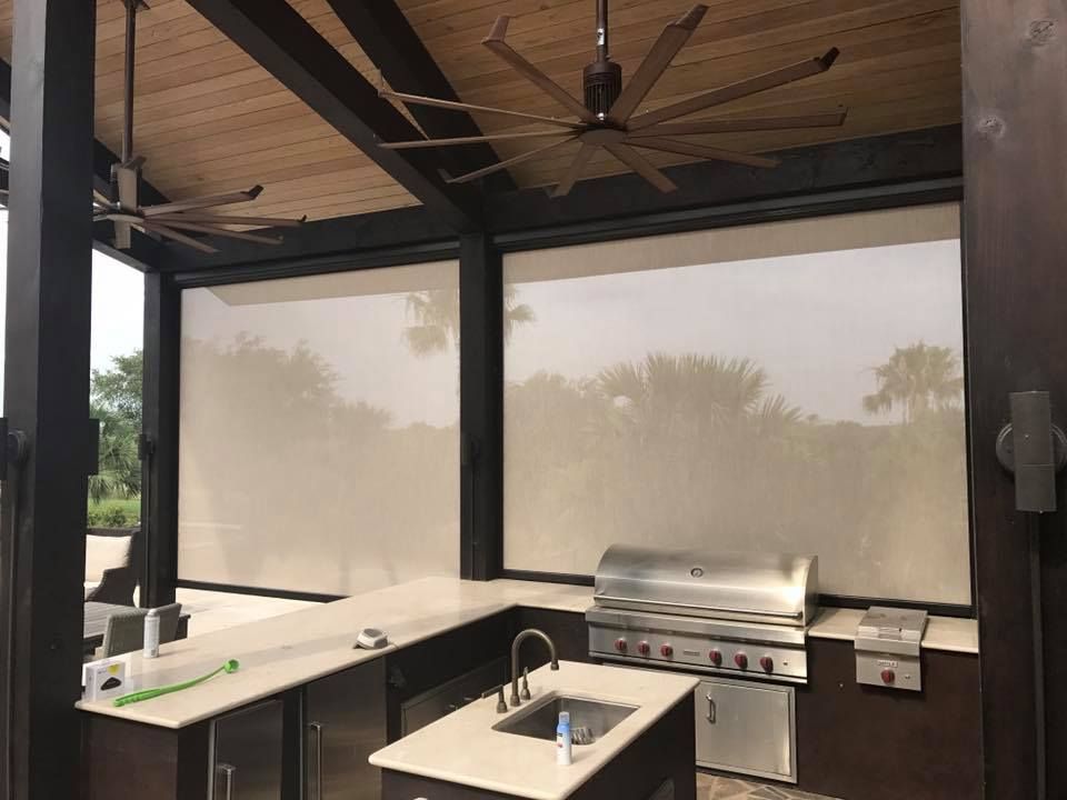 a kitchen with a grill , sink , and ceiling fan .