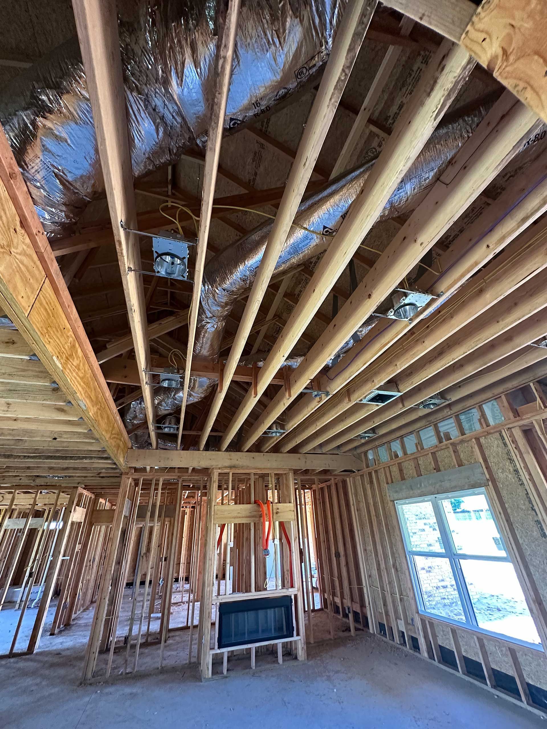 a room in a house under construction with a fireplace
