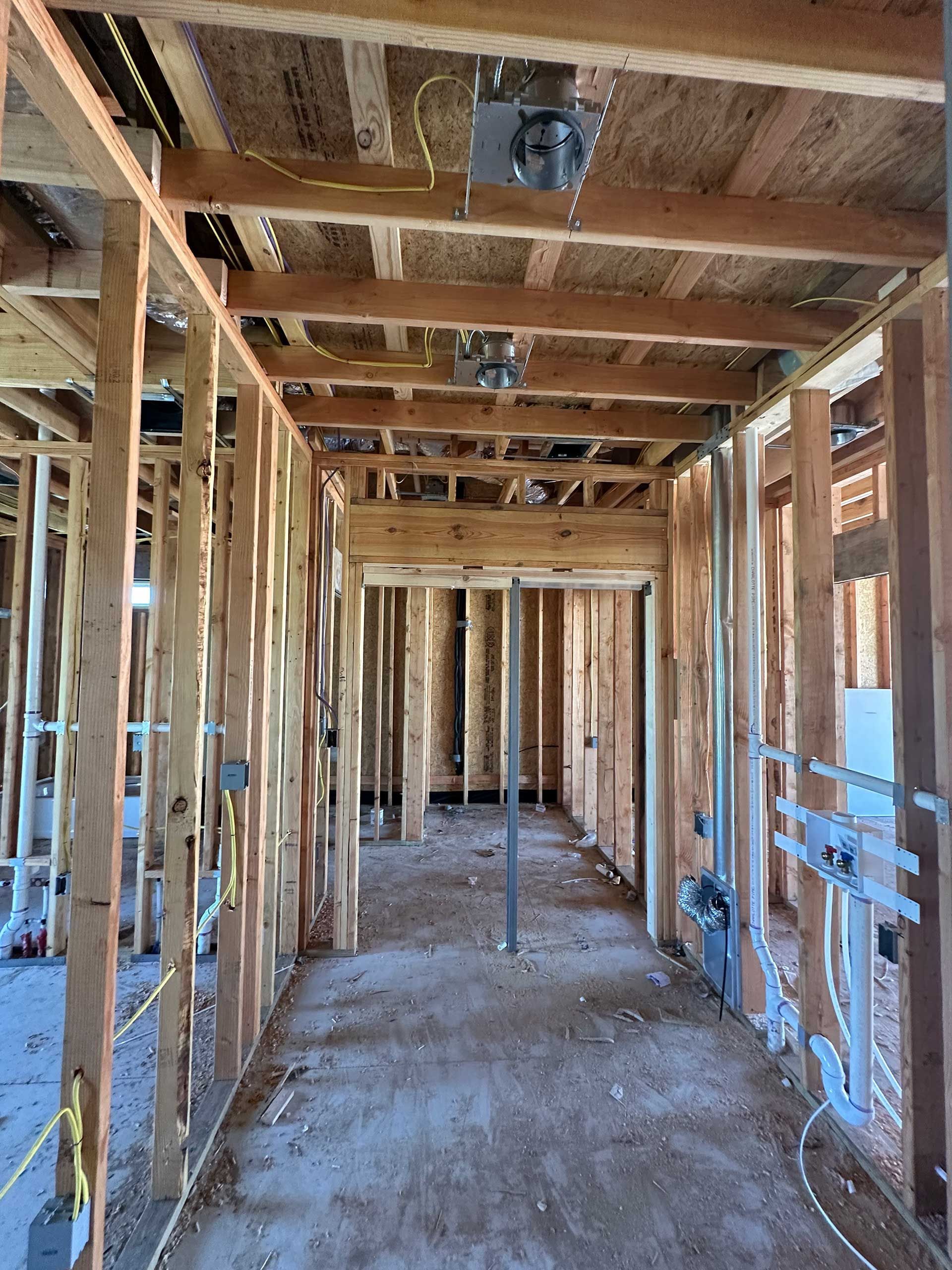 a hallway in a house under construction with wooden beams