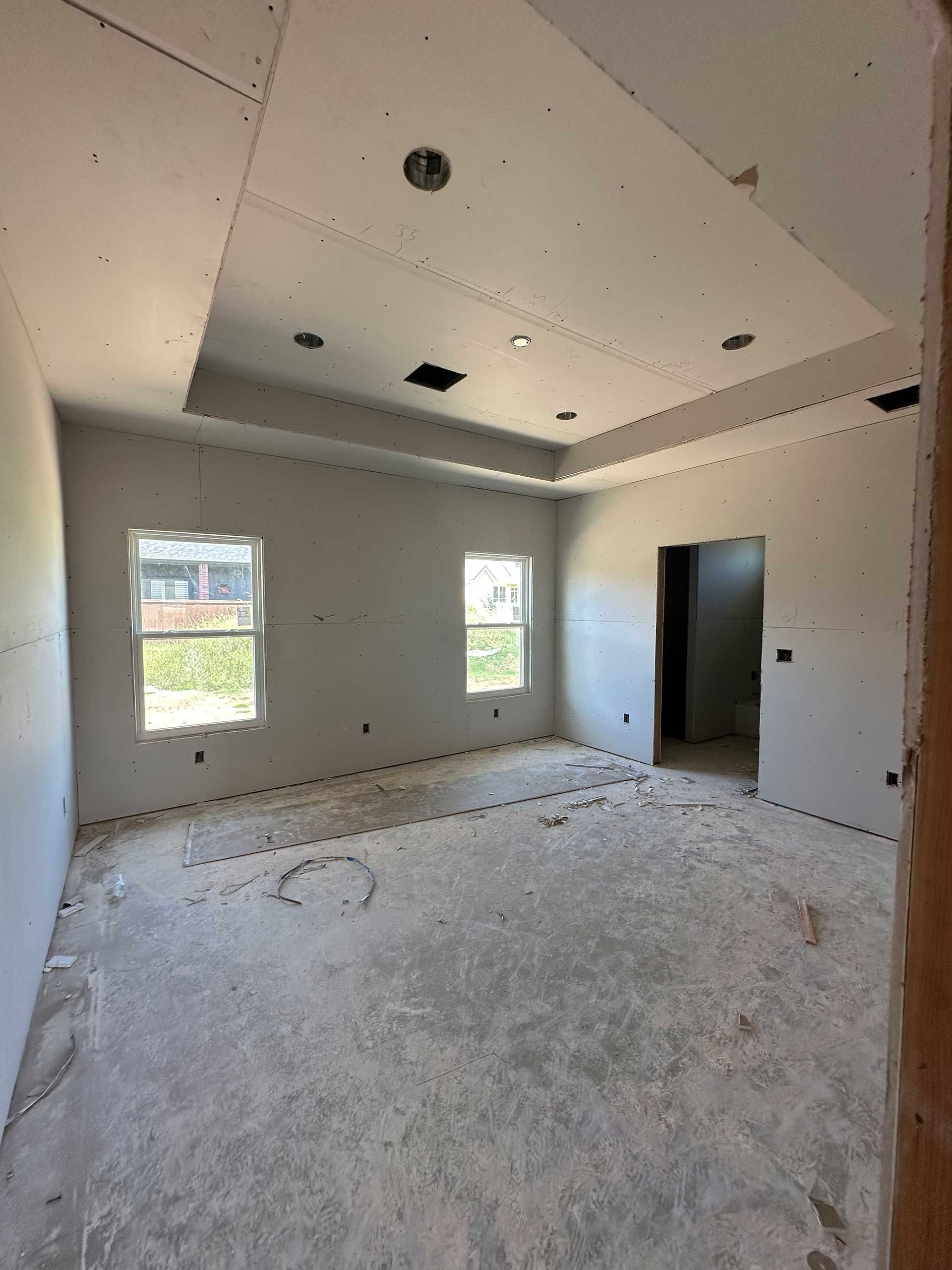 a large empty room with a ceiling that is being built