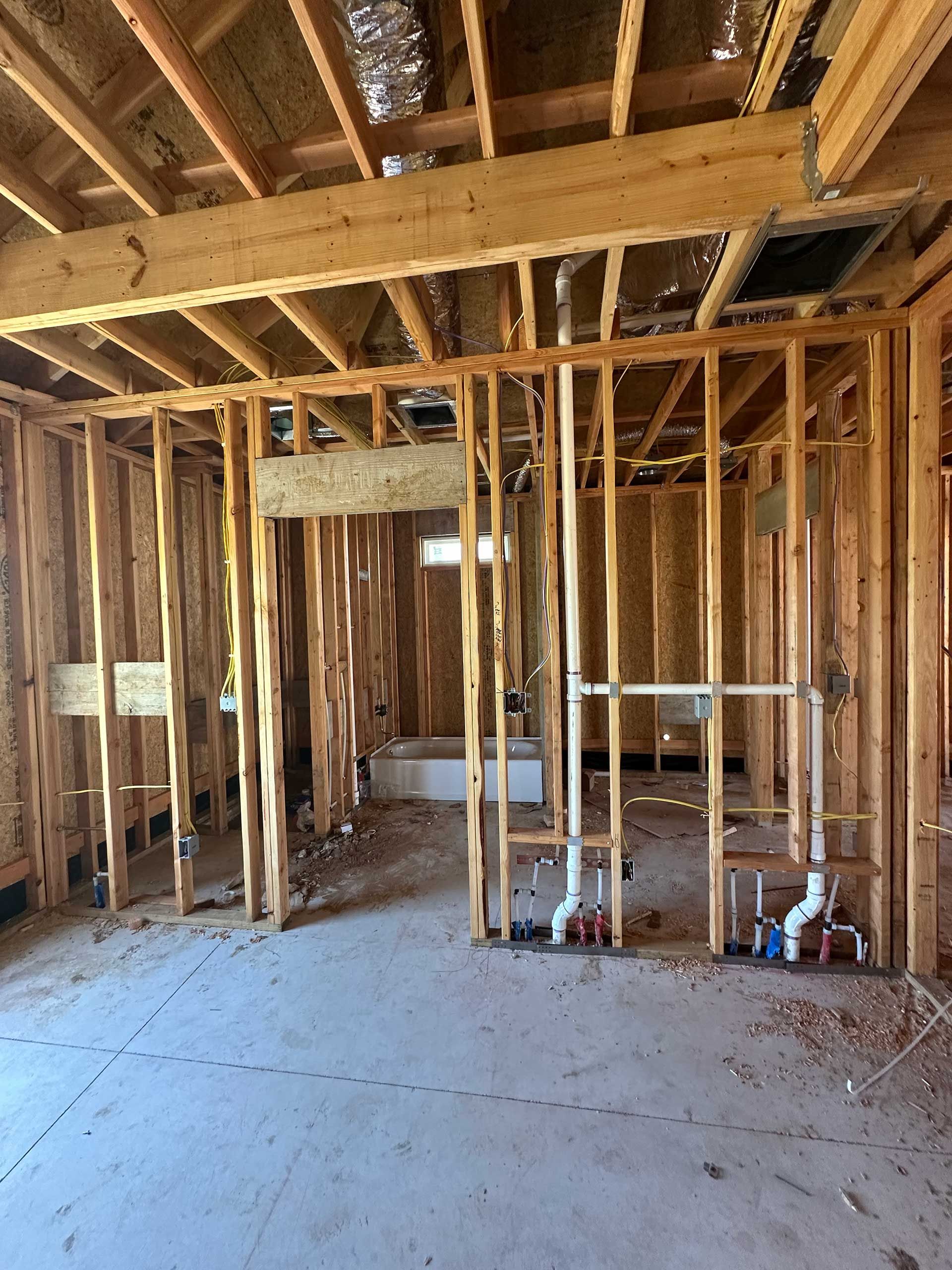 the inside of a house under construction with wooden beams and pipes