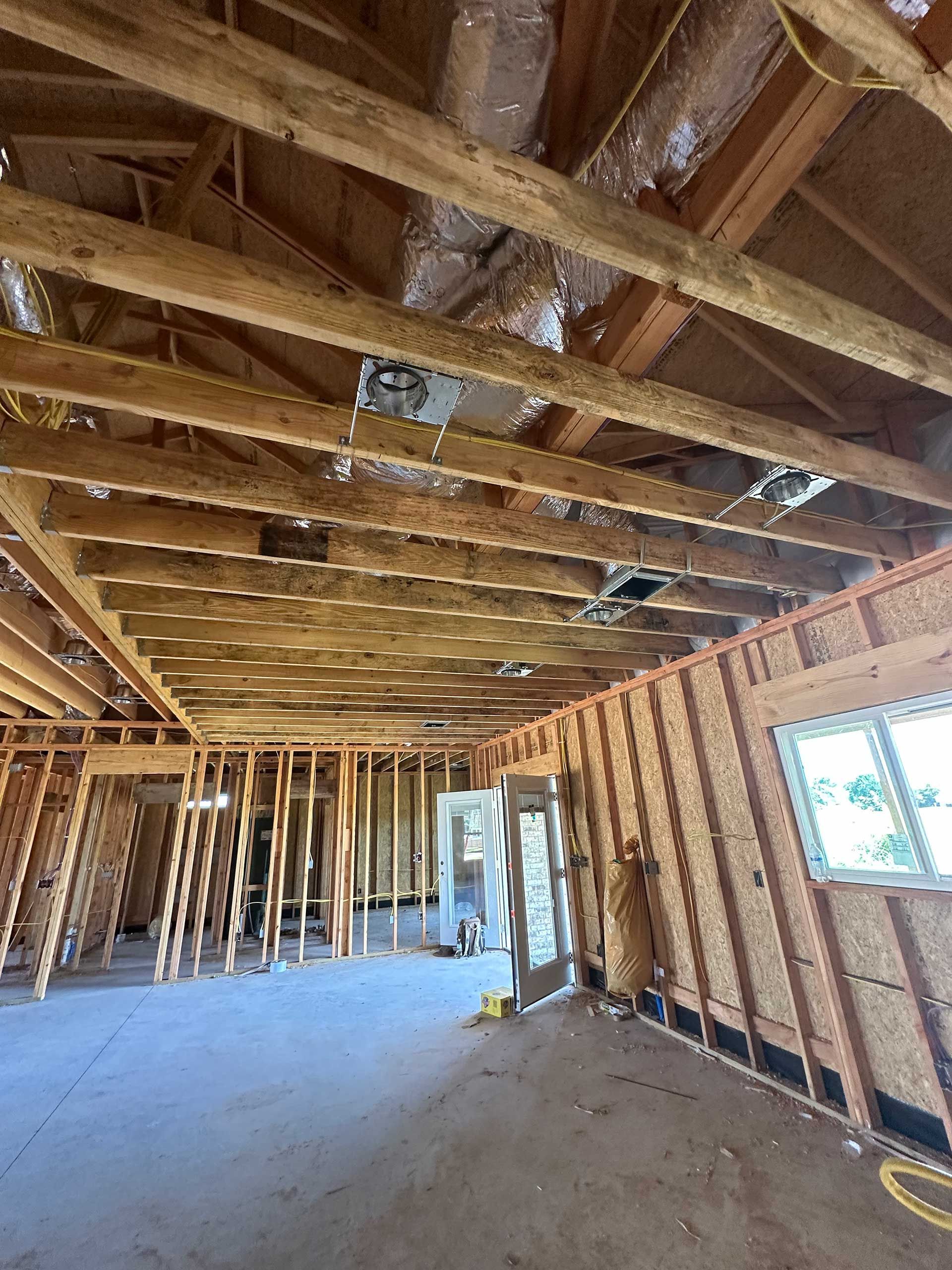 the inside of a building under construction with a lot of wooden beams