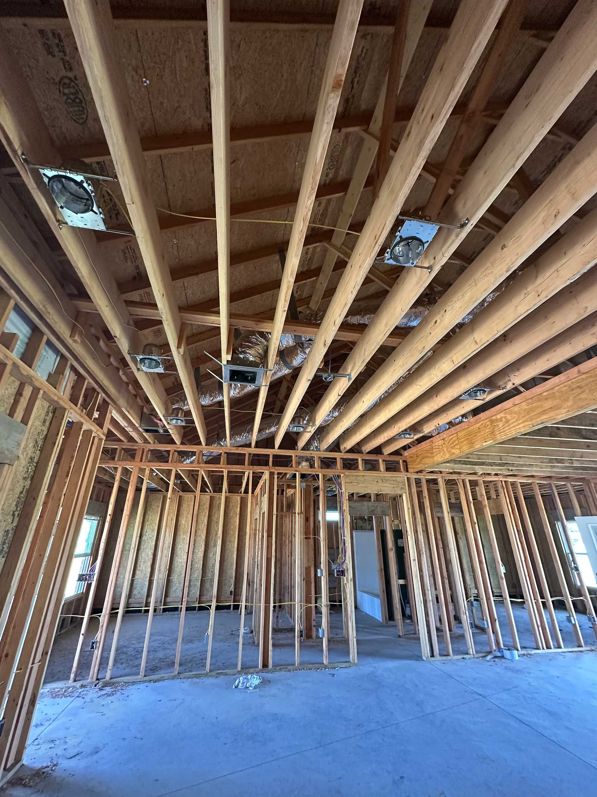 a room with a lot of wooden beams hanging from the ceiling