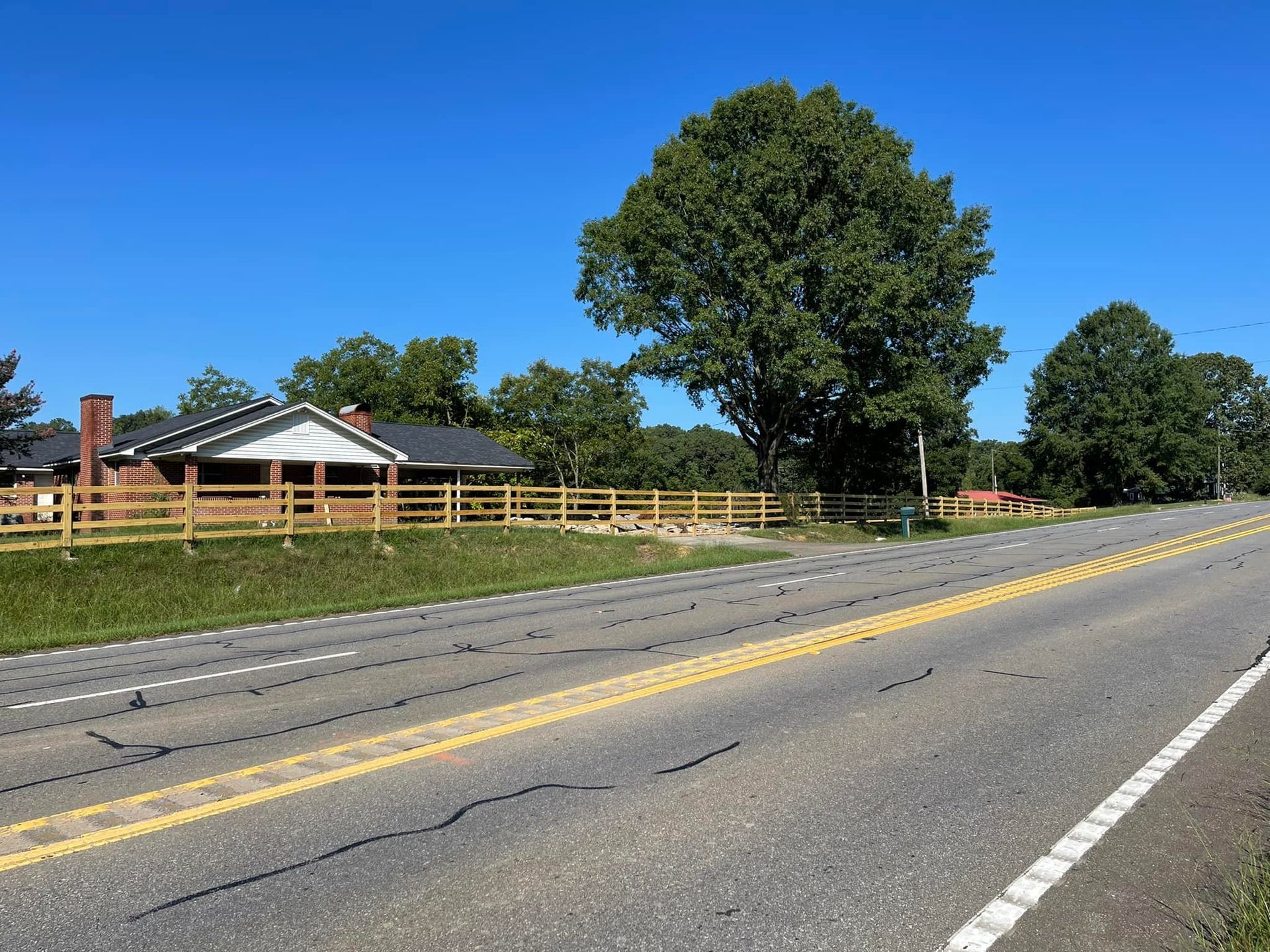 A road with a house on the side of it