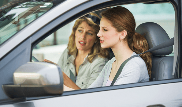 Adult in a driving lesson with her instructor