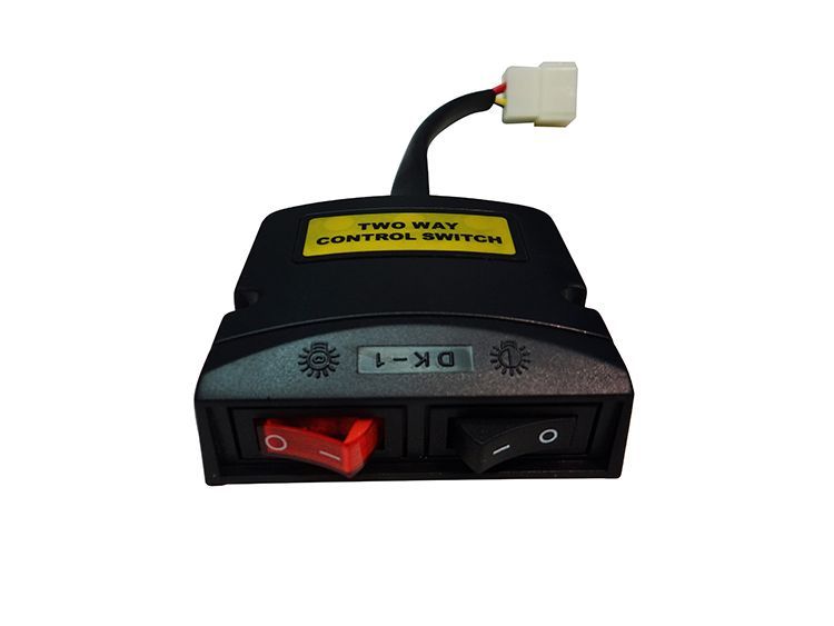 Black control switch with red and black toggles, white connector, and yellow label.