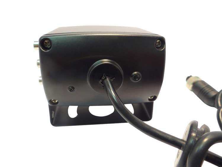 Black camera with attached cable, on a white surface.